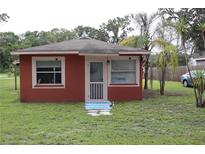 Charming single-story home featuring a cozy front porch and well-maintained lawn at 1006 Gray St, Plant City, FL 33563