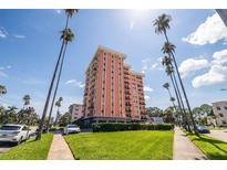 Beautiful multi-story condo building featuring private balconies surrounded by lush green lawns and mature palm trees at 1120 N Shore Ne Dr # 503, St Petersburg, FL 33701