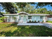 Charming home with a well-manicured lawn, stone accents, and beautiful curb appeal at 2121 Dodge St, Clearwater, FL 33760