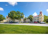 Spacious condo building with manicured lawn, ample parking, and classic architectural details at 2430 Florentine Way # 40, Clearwater, FL 33763