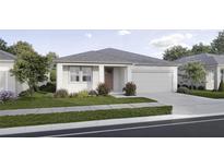 Charming single-story home with a well-maintained lawn, a driveway and an attached two car garage at 2791 Peake St, North Port, FL 34286