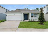 Charming one-story home featuring a two-car garage, manicured lawn, and welcoming front entry at 2791 Peake St, North Port, FL 34286