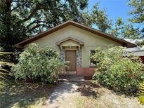 Charming single-story home with a stone accent wall and vibrant shrubbery around the front entrance at 2800 13Th N Ave, St Petersburg, FL 33713