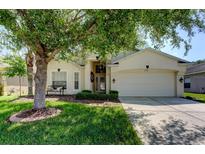 Charming single-story home featuring a well-manicured lawn and a spacious two-car garage at 4522 Lisette Cir, Brooksville, FL 34604