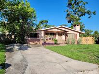 Charming single-story home featuring a cozy front porch and a well-maintained lawn at 6285 52Nd N Ct, St Petersburg, FL 33709