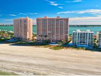 Expansive beachfront view of condominium buildings with white sand and ocean in the background at 1340 Gulf Blvd # 12A, Clearwater Beach, FL 33767