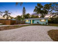 Charming single story home with a well kept lawn, wooden fence, and inviting landscaping at 201 South St, Palm Harbor, FL 34683