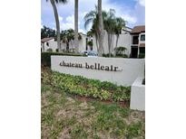 Chateau Belleair community sign with lush landscaping and condominium buildings in the background at 2209 Belleair Rd # C3, Clearwater, FL 33764