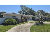 Charming single story home with a driveway and well-maintained landscaping at 2502 Tropical Shores Se Dr, St Petersburg, FL 33705