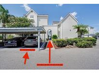Exterior view of parking area with covered parking and walkway to unit at 3127 W Sligh Ave # 101C, Tampa, FL 33614