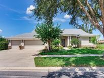Charming single-story home featuring a three-car garage, manicured lawn, and inviting front entrance at 3503 Graycliff Ln, Brandon, FL 33511