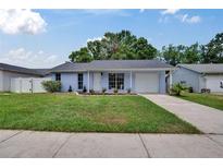 Charming single-story home with a well-manicured lawn and attached garage at 3733 Mendocino St, New Port Richey, FL 34655