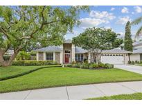 Charming single-story home featuring lush landscaping, brick accents, and a welcoming front entrance at 5604 Pine Bay Dr, Tampa, FL 33625