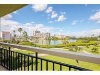 Enjoy breathtaking water views from this balcony, framed by lush greenery and clear skies at 7893 Sailboat Key S Blvd # 304, South Pasadena, FL 33707