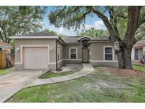Charming single-story home with stucco exterior, garage, and mature landscaping at 1605 Prescott S St, St Petersburg, FL 33712