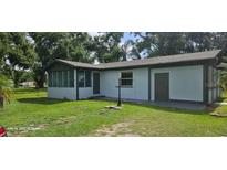 Charming single-story home with a screened porch, neutral paint, and well-maintained lawn at 1908 S Kingsway Rd, Seffner, FL 33584