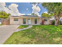 Charming single-story home with well-maintained lawn and a welcoming walkway to the front door at 2848 Homewood St, Clearwater, FL 33759