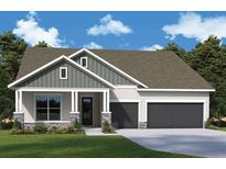 Charming home featuring stone accents, a covered entry, two-car garage, and well-manicured front lawn at 31504 Hayman Loop, Wesley Chapel, FL 33545