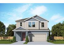 Two-story home with neutral siding, complemented by a two-car garage and well-maintained front lawn at 3275 Guanabana Xing, Wesley Chapel, FL 33543