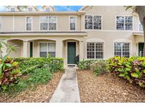Charming townhouse featuring a stucco facade, lush landscaping, and inviting entryway at 4668 66Th N Pl, Pinellas Park, FL 33781