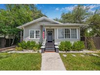 Charming single-story home featuring a well-manicured lawn and inviting front porch at 5101 N Suwanee Ave, Tampa, FL 33603