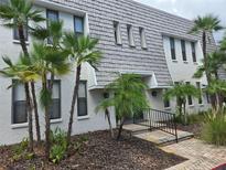 Inviting condo with manicured landscaping and beautiful palm trees adding a touch of tropical paradise at 702 Lyndhurst St # 822, Dunedin, FL 34698