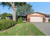 Charming single-story brick home with a two-car garage and lush landscaping at 7400 Locust Ne St, St Petersburg, FL 33702