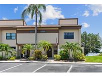 Inviting townhome exterior with manicured landscaping, mature palm trees and well-maintained facade at 9209 Seminole Blvd # 13, Seminole, FL 33772