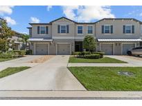 Charming townhomes feature attached garages, manicured landscaping, and classic architectural details at 9768 Pembrooke Pines Dr, Sun City Center, FL 33573