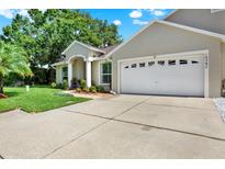 Charming single-Gathering home with a well-manicured lawn and an attached two-car garage at 10597 Alvarado Ct, Seminole, FL 33772