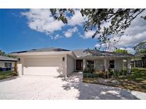 Charming single-story home with a well-maintained front yard and an attached two-car garage at 1536 Palmetto St, Clearwater, FL 33755