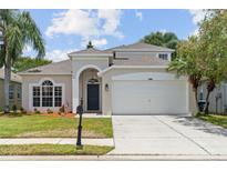 Charming two-story home with well-manicured lawn, a two-car garage, and beautiful landscaping at 1800 Loch Haven Ct, Trinity, FL 34655