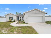 Charming single-story home featuring a two-car garage and a well-manicured front yard with a tidy walkway at 9429 Northcliffe Blvd, Spring Hill, FL 34606