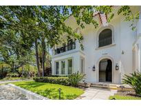 Charming two-story home with arched doorway, balcony, manicured lawn, and lush landscaping creates curb appeal at 1731 W Watrous Ave # 202, Tampa, FL 33606