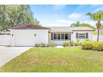 Charming, renovated single story home featuring a well-manicured front lawn and a brick facade at 1901 76Th N Ave, St Petersburg, FL 33702