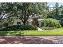Charming single-story home featuring stone accents, mature landscaping, and a brick-paved street at 211 60Th S Ave, St Petersburg, FL 33705