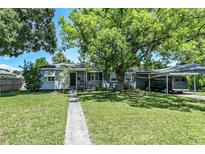 Charming single-story home with a covered carport and mature trees in a lush front yard at 3317 15Th N St, St Petersburg, FL 33704