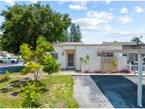 Charming single-story home with lush landscaping and a covered parking area at 4326 Fern Glen St, Holiday, FL 34691
