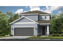 Charming two-story home showcasing a modern design and neutral color palette, complemented by a well-manicured lawn at 723 Steel Dr, Apollo Beach, FL 33572