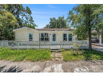 Charming single-story home featuring a cozy front porch and mature trees in a quiet neighborhood at 814 Florida Ave, Palm Harbor, FL 34683