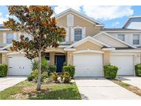 Charming townhome features a well-manicured lawn, attached garage, and a welcoming front entrance at 9630 Carlsdale Dr, Riverview, FL 33578