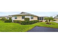 Inviting villa with manicured lawn and lush landscaping creating a welcoming curb appeal at 2814 Highlands Blvd # B, Palm Harbor, FL 34684