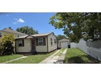 Cozy single-Gathering home featuring neutral siding, a well-maintained lawn, and a detached single-car garage at 3131 Melton N St, St Petersburg, FL 33704