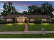 Charming single-story brick home with a well-manicured lawn and inviting front porch at 37821 Willingham Ave, Dade City, FL 33525