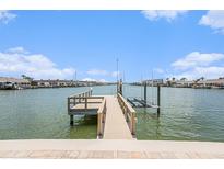 Stunning waterfront property featuring a private boat dock and lift, perfect for the avid boater at 384 Boca Ciega Point Blvd, St Petersburg, FL 33708