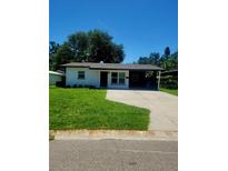Charming single-story home featuring a welcoming front yard and convenient carport at 5627 Commonwealth N Ave, St Petersburg, FL 33703