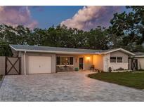 Charming single-story home with a well-maintained lawn and a driveway that's perfect for additional parking at 1144 Woodbrook Dr, Largo, FL 33770