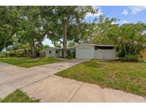 Charming single-story home with a well-maintained lawn and mature trees providing shade at 1309 11Th W Ave, Palmetto, FL 34221