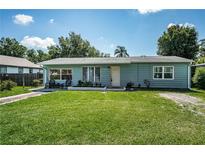 Charming single-story home with a well-maintained lawn and inviting front porch under a sunny, blue sky at 509 N Washington Ave, Clearwater, FL 33755