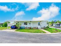 Charming single-story home with carport, well-maintained lawn, and lovely curb appeal at 9790 66Th N St # 37, Pinellas Park, FL 33782